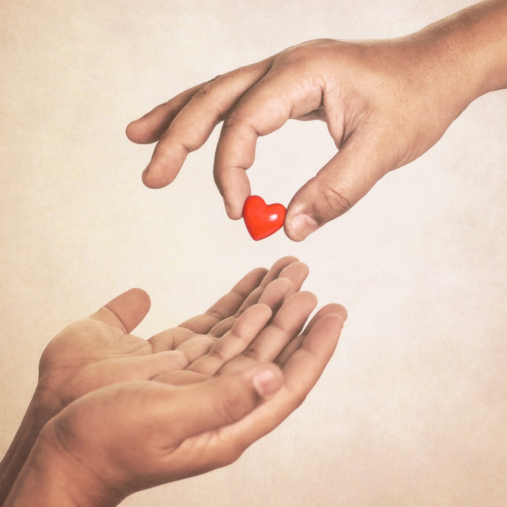 Image of two hands and a heart to recognise helping charity