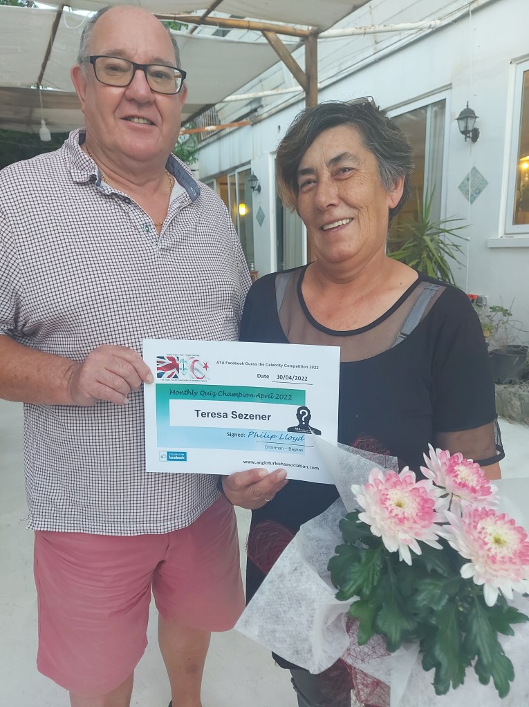 APRIL 2022 Monthly prize winner (person with the most correct guesses during the month) is: - Teresa Sezener seen here receiving her prize and certificate from the association chairman