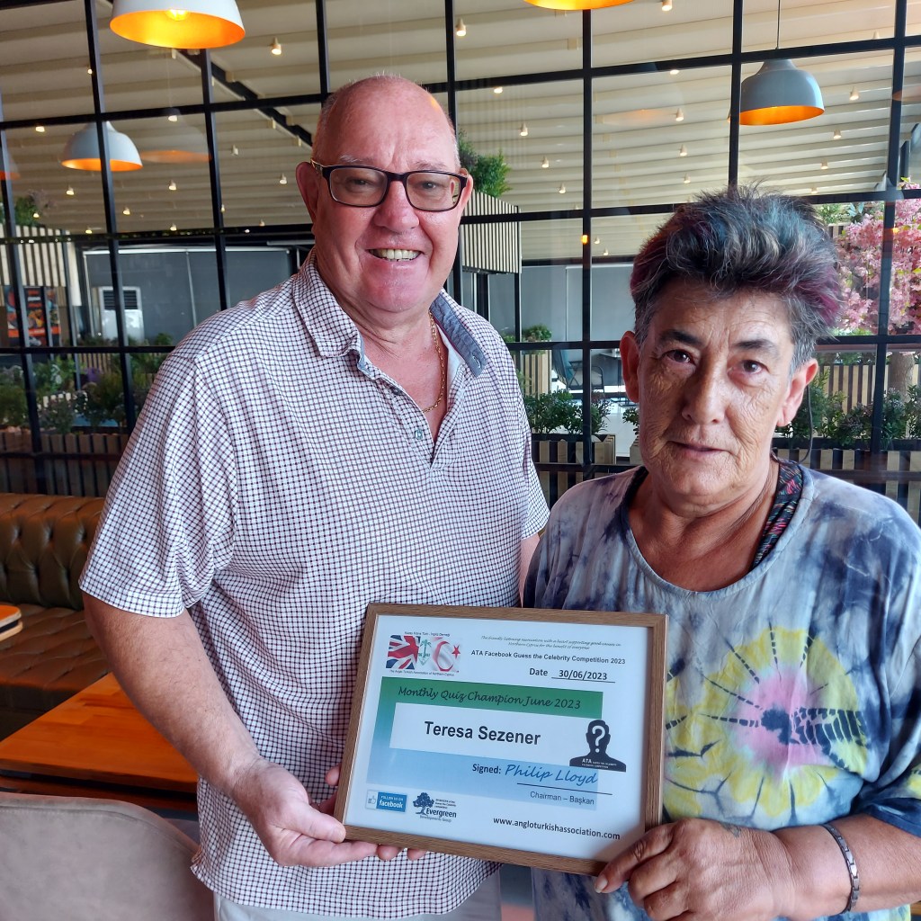 JUNE 2023 Monthly prize winner (person with the most correct guesses during the month) is: –  Teresa Sezener seen here receiving her winners certificate from the associations chairman