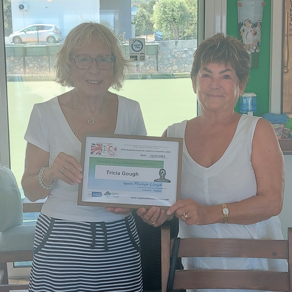 JULY 2023 Monthly prize winner (person with the most correct guesses during the month) is: –  Tricia Gough (L) seen here receiving her winners certificate from the associations Barbara Johnson