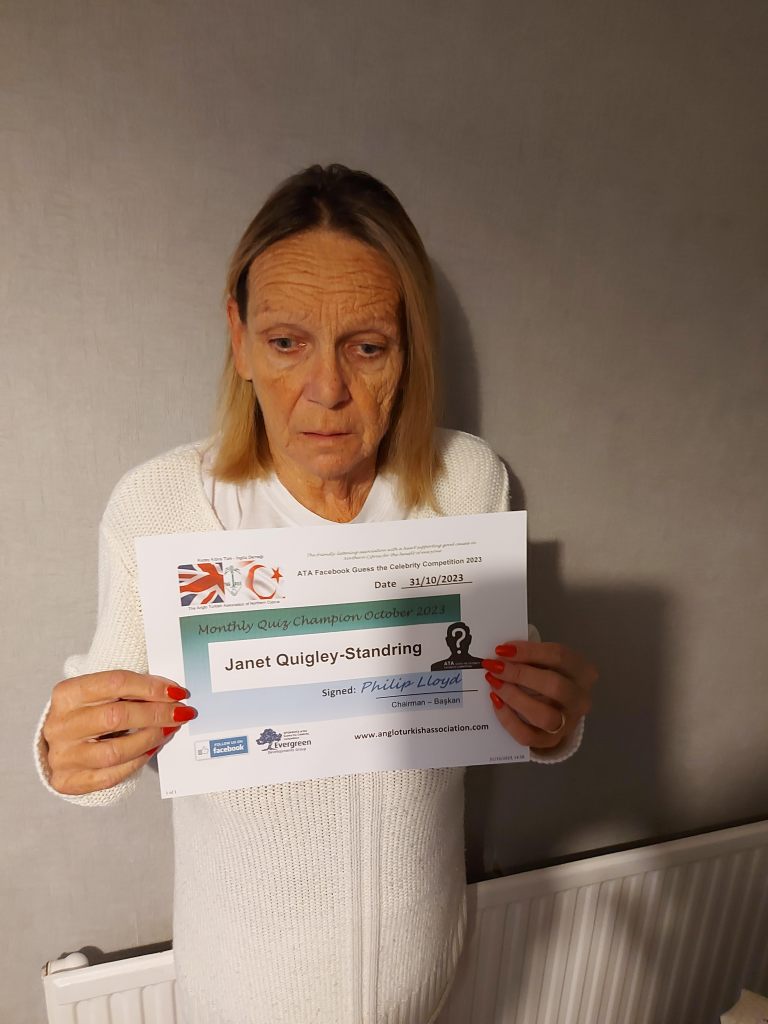 OCTOBER 2023 Monthly prize winner (person with the most correct guesses during the month) is: –  Janet Quigley-Standring seen here in the UK with a copy of her winners’ certificate (the framed original will be presented to Janet when she returns to Northern Cyprus).
